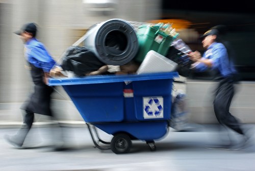 Trained staff wearing high-visibility PPE handling waste containers